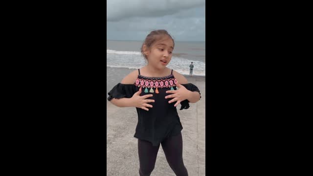 Cute girl dancing on the Beach